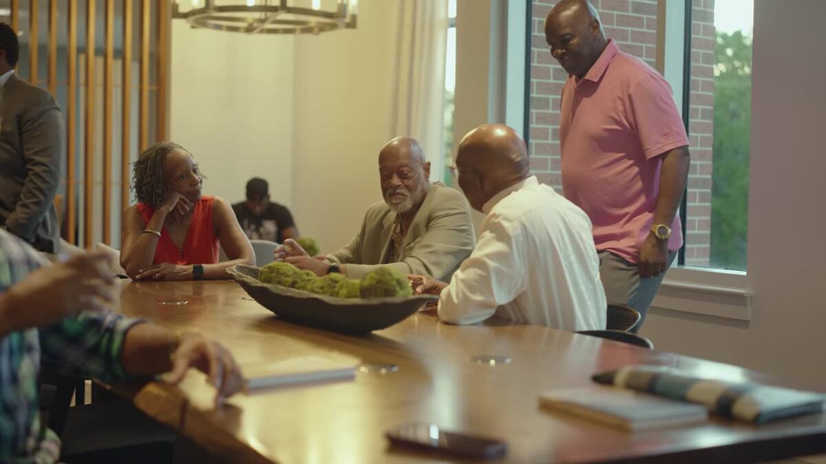 Guests in conversation around a table at Booked and Busy